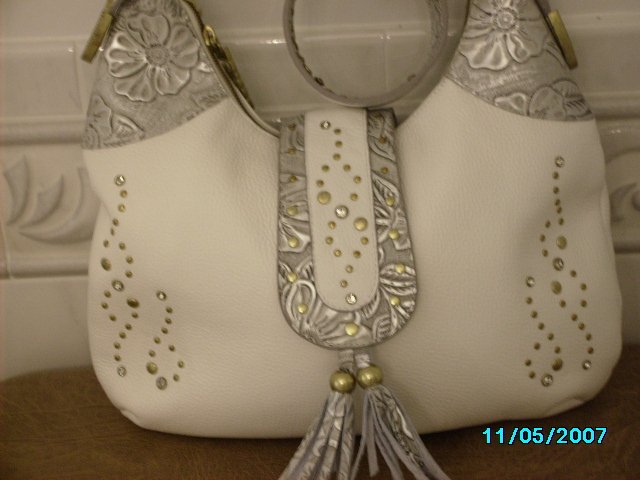 Charm and Luck pebbled leather designer handbag.