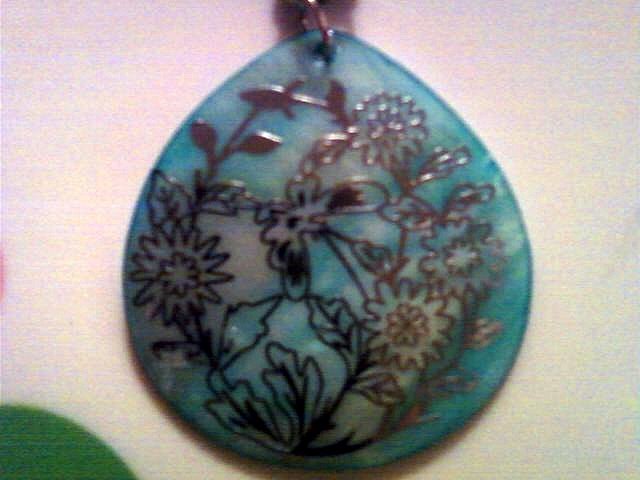 Beautiful Mother of Pearl Pendent with Silver Floral Detail.