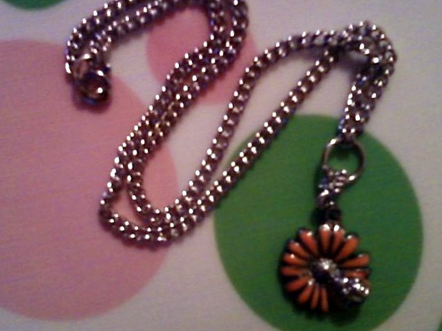 Silver Ladybug on a Orange Flower Necklace.