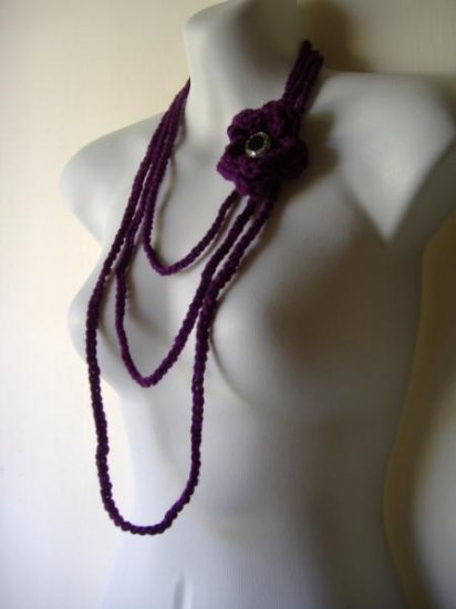the long flower necklace in eggplant purple.
