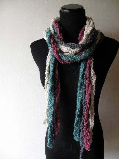 the twisted colors scarf in gray, teal, cream, and purple.