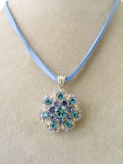 Silver, clear and blue crystal pendant;blue suede necklace