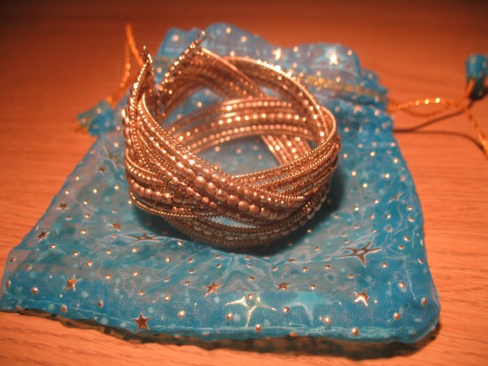 Intricately woven bead cuff in gold