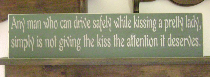 Primitive Sign, Any man who can drive safely while kissing a pretty lady simply is not giving