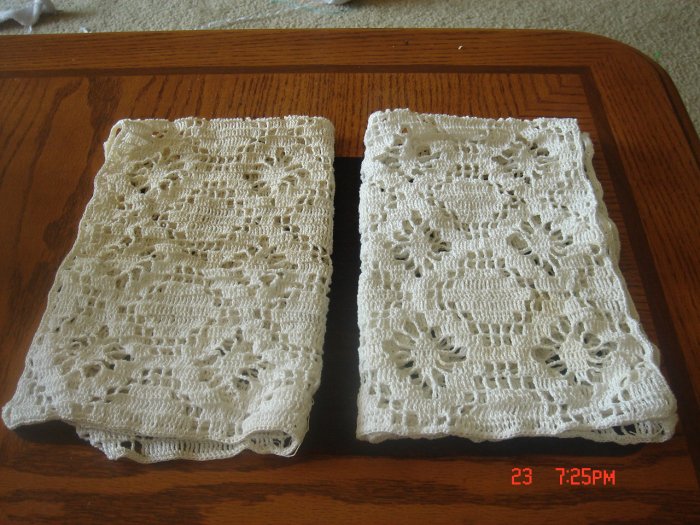 A pair of crochet place mat