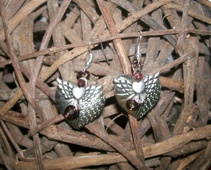 Heart shaped earrings with angel wings.