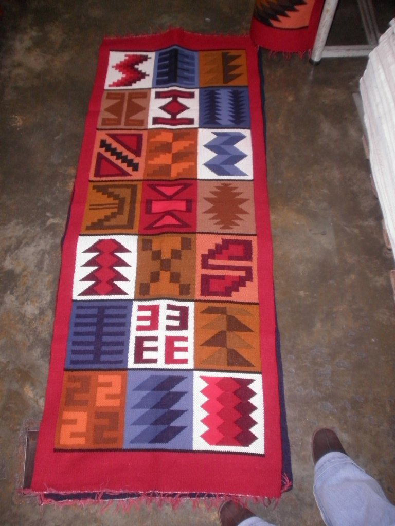 Peruvian hand weaved red wool rug with native geometric designs