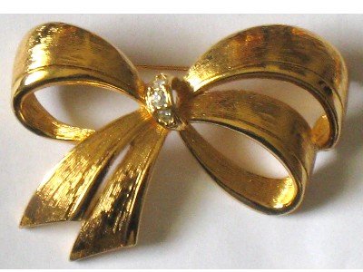 Gold tone Bow Pin Signed Avon, Rhinestone Center