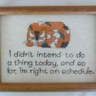 Orange calico cat on lazy day schedule finished completed cross stitch