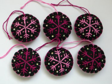 Handmade pink fuchsia snowflake felt ornament on black lot