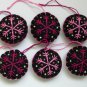 Handmade pink fuchsia snowflake felt ornament on black lot