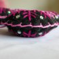 Handmade pink fuchsia snowflake felt ornament on black lot
