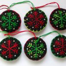 Handmade red and green snowflake felt ornaments on black lot