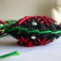 Handmade red and green snowflake felt ornaments on black lot