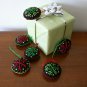Handmade red and green snowflake felt ornaments on black lot