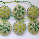 Handmade light and dark green snowflake felt country ornament on brown lot Handmade light and dark green snowflake felt country ornament on brown lot