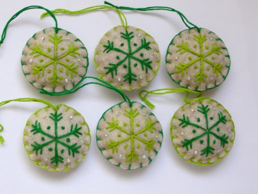 Handmade light and dark green snowflake felt country ornament on brown lot