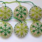 Handmade light and dark green snowflake felt country ornament on brown lot