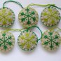 Handmade light and dark green snowflake felt country ornament on brown lot
