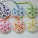 Handmade rainbow colorful snowflake felt ornament on white lot
