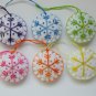 Handmade rainbow colorful snowflake felt ornament on white lot