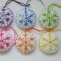 Handmade rainbow colorful snowflake felt ornament on white lot