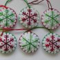 Handmade green and red classic snowflake felt ornament on white lot