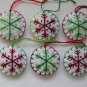 Handmade green and red classic snowflake felt ornament on white lot