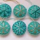 Handmade brown and blue snowflake felt ornament on aqua lot Handmade brown and blue snowflake felt ornament on aqua lot