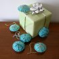 Handmade brown and blue snowflake felt ornament on aqua lot