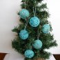 Handmade brown and blue snowflake felt ornament on aqua lot