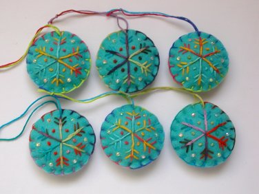 Handmade yellow blue rainbow snowflake felt ornament on aqua lot