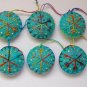 Handmade yellow blue rainbow snowflake felt ornament on aqua lot