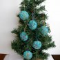 Handmade yellow blue rainbow snowflake felt ornament on aqua lot