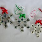 Recycled magazine page ornament white snowflake red green bow
