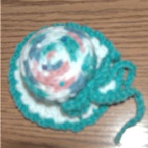 hand crocheted hat pincushion in teal, white and multi