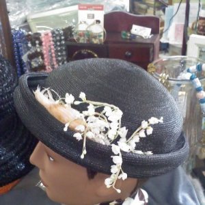 An Austelle Fashion vintage black topper hat with lily of the valley silk flowers