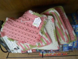 Hand crocheted hot pads (4) and a dish cloth of cotton yarn in pinks green cream