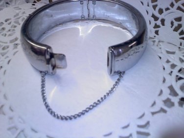 Clamper cuff style hinged silvertone vintage bracelet with safety chain - made in Hong Kong