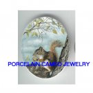 SQUIRREL HOLDING NUT UNSET CAMEO PORCELAIN CABCOHON