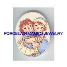 RAGGEDY ANN AND ANDY HUGGING UNSET PORCELIAN CAMEO CAB