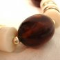Mixed Lucite plastic bead necklace white, root beer, gold opera length vintage ll3254
