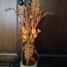 Amber Bottle, Jute & metal leaf w/ Orange buds, berries, Green, Brown & Cream Wheat w/ glass rocks
