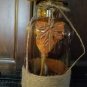 Amber Bottle, Jute & metal leaf w/ Orange buds, berries, Green, Brown & Cream Wheat w/ glass rocks