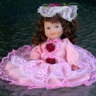 Porcelain Doll - dressed in  pink.