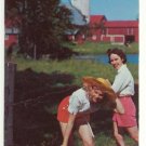 TWO CUTE FARMERETTES CROSSING A BARBED WIRE -P/C -C-254