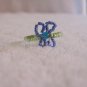 Butterfly ring, dark blue on various green