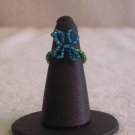 Butterfly ring, blue on dark green