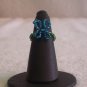 Butterfly ring, blue on dark green