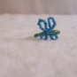 Butterfly ring, blue on dark green